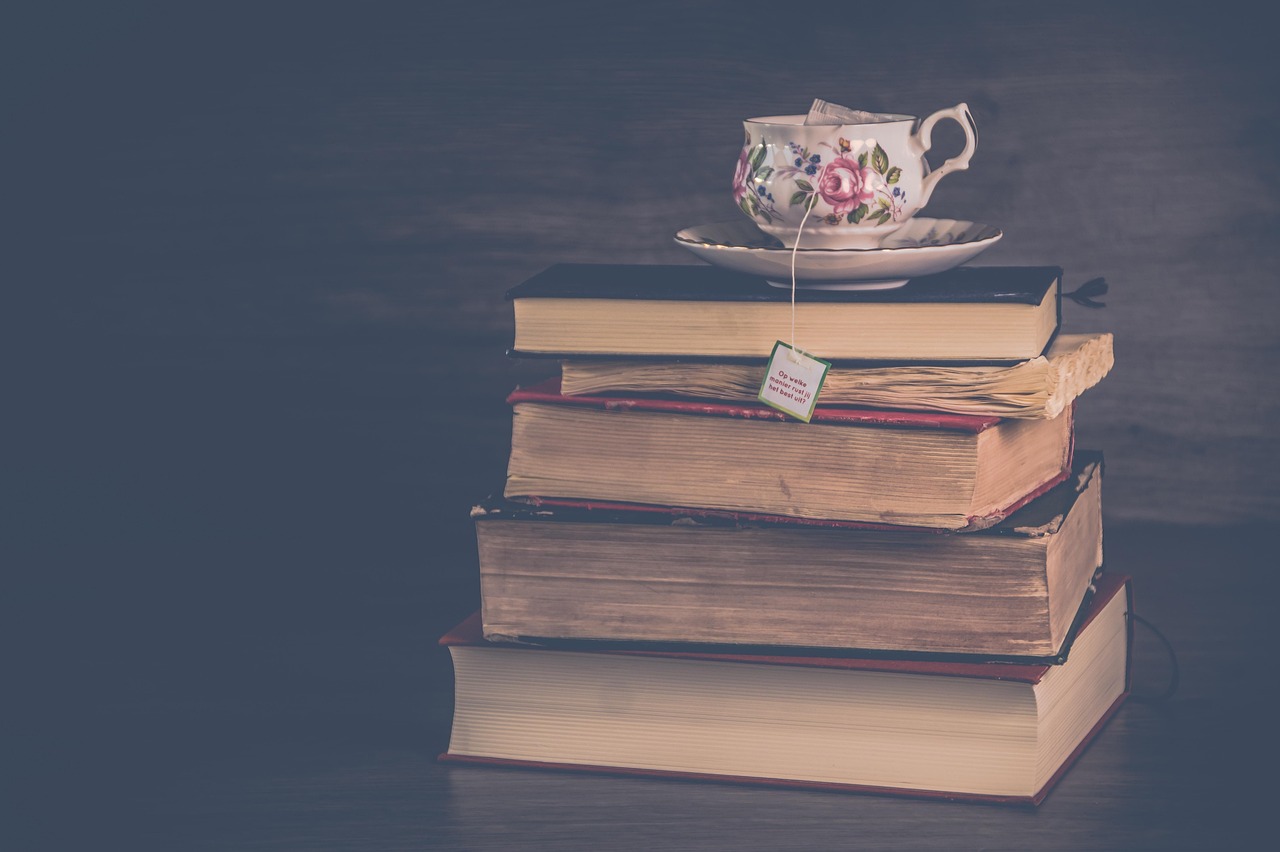 A stack of books with a teacup on top